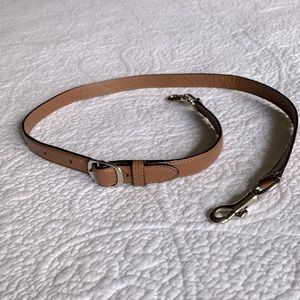 Coach adjustable strap in saddle color.